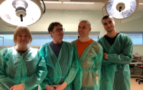 Jonathan Falconer with author and photographers in an operating theatre